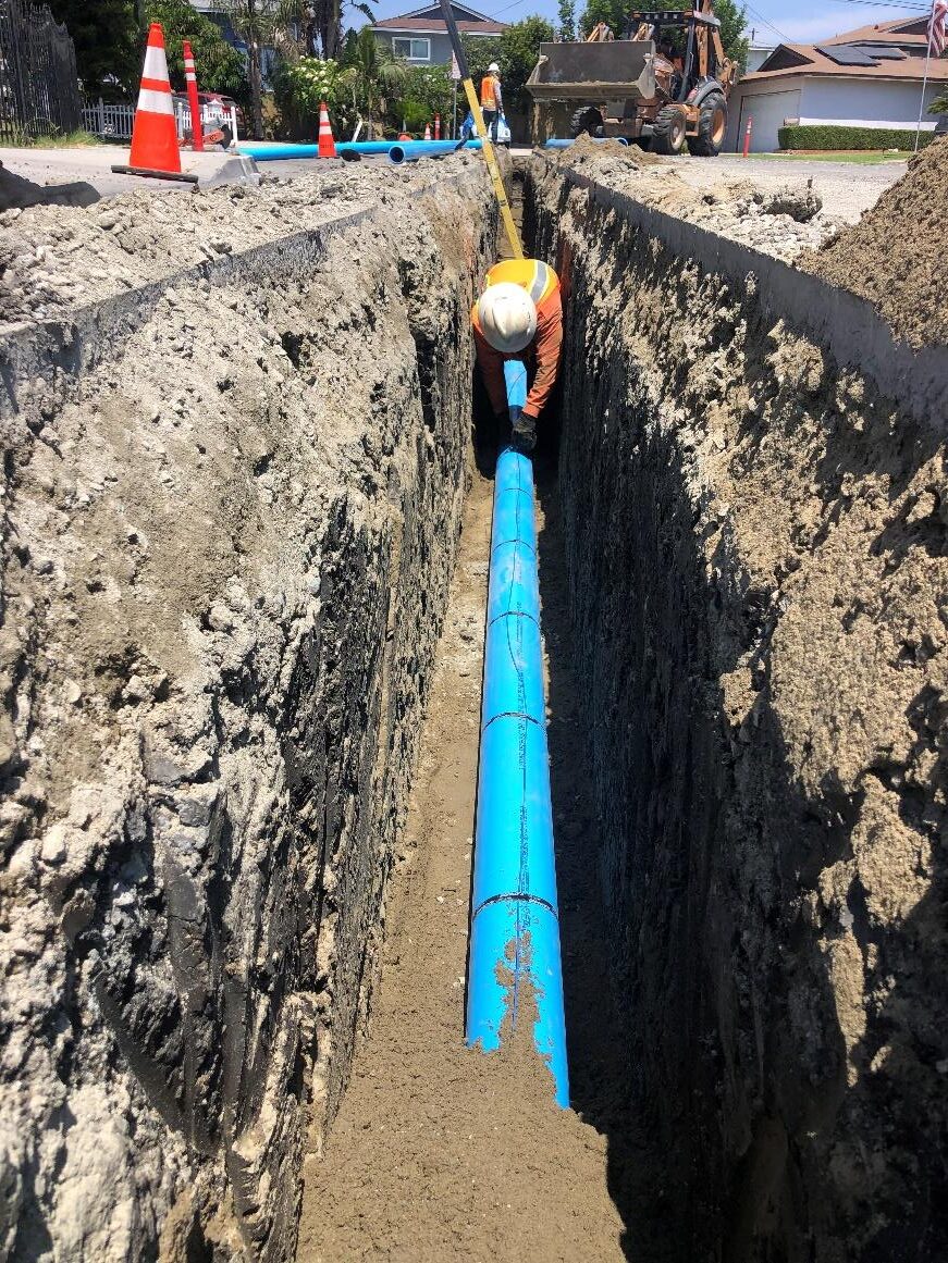 Photo 2: Installing 6” PVC pipe in the trench on Caffel Way. 