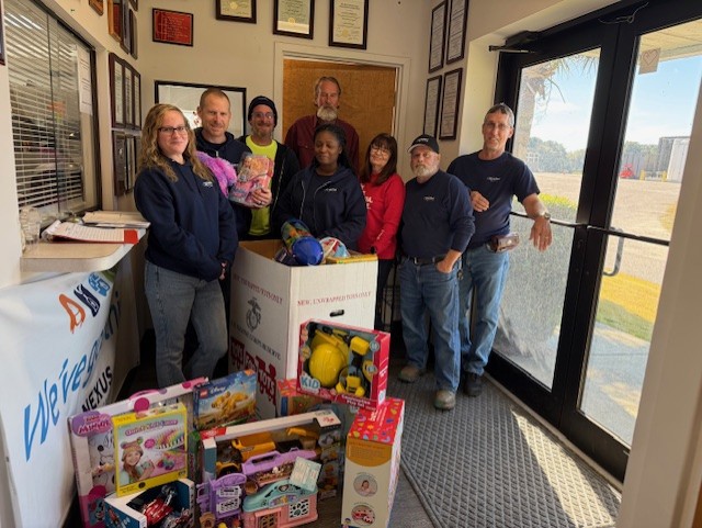 Toys for Tots group shot: Danelle Southerland, Brette Southerland, AJ Castle, Shereka Mack, Vicky Dyke, Randy Roberts, Ed McCray with Mike Agin behind Shereka.